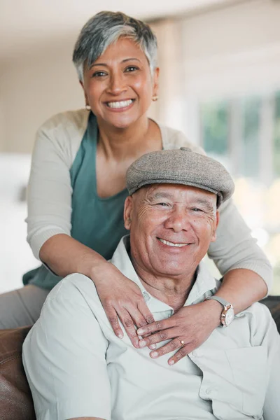 stock image Senior couple, portrait and love in home for happy retirement, loyalty to partner and commitment to marriage. Man, woman and smile for support, trust and freedom to relax in living room together.