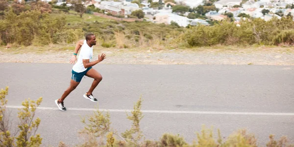 Morning, road and a black man running for fitness, exercise and training for a marathon. Sports, health and an African runner or fast person in the street for a workout, cardio or athlete commitment.