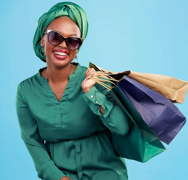 Studio bag, shopping and happy customer, black woman or client excited for holiday fashion spree, sales or mall market deal. Financial freedom, retail loan and rich African person on blue background.