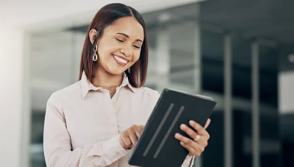 Happy businesswoman in office with, tablet and scroll on email, HR schedule or online for feedback. Internet, networking and communication on digital app, woman with smile at human resources agency