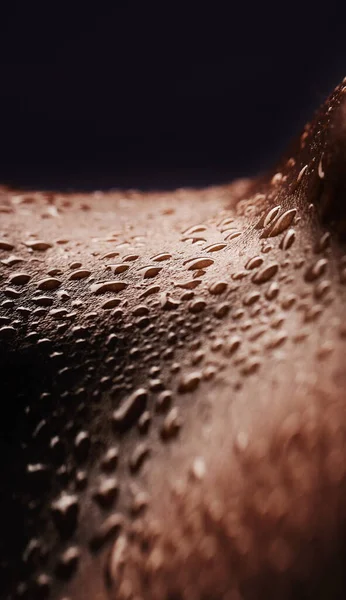 Skin, water drops and wet body of a person for dermatology, skincare and hygiene. Zoom on aesthetic model for art deco, human and sweat with droplets, creative and wellness on a black background.