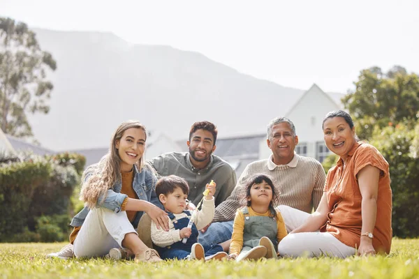 Big family, portrait or children in nature to relax with grandparents on holiday vacation at home. Dad, picnic or happy kids bonding with mom, grandmother or grandfather on grass or garden together.