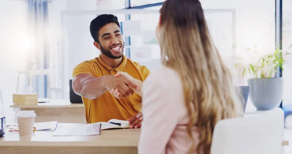 Smile, business people and handshake for partnership, deal or introduction in workplace. Happy, man and woman shaking hands for agreement, b2b or onboarding, congratulations or welcome to company
