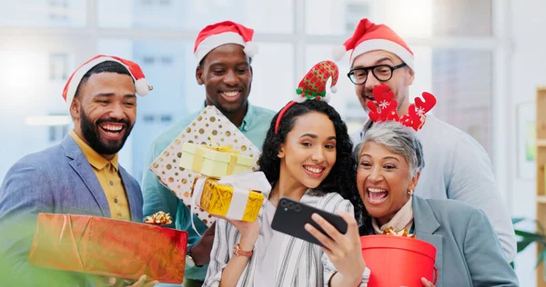 Creative people, Christmas and selfie for party celebration, festive season or December holiday at office. Happy group of employees smile at work event for gifts, surprise or photo in memory and vlog.
