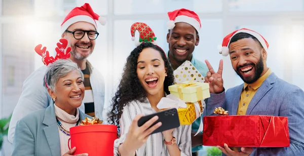 Creative group, Christmas and selfie for party celebration, festive season or December holiday at office. Happy people or employees smile at work event for gifts, surprise or photo in memory and vlog.