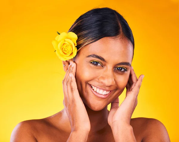 Makeup, flower and portrait of woman in studio with beauty, glow and cosmetic face routine. Skincare, rose and young female model from Mexico with facial treatment isolated by yellow background