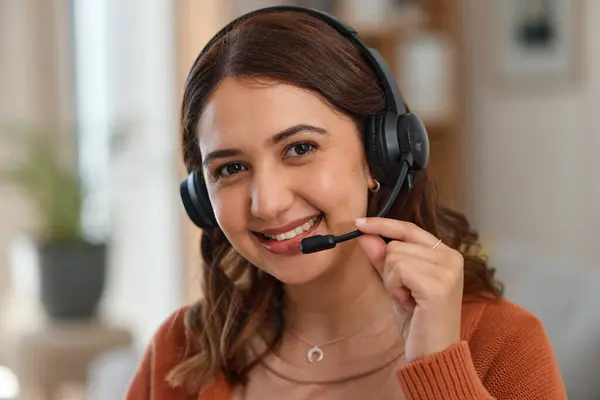 Portrait, smile and remote call center with a woman in a home for customer service consulting. Face, communication and headset with a happy young entrepreneur working on a living room for support.