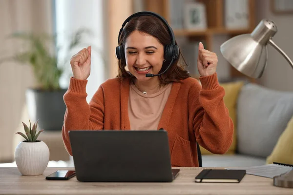 Happy woman, laptop and fist pump in call center, celebration or winning promotion in remote work at home. Excited female person, consultant or agent freelancer smile for discount, sale or target.