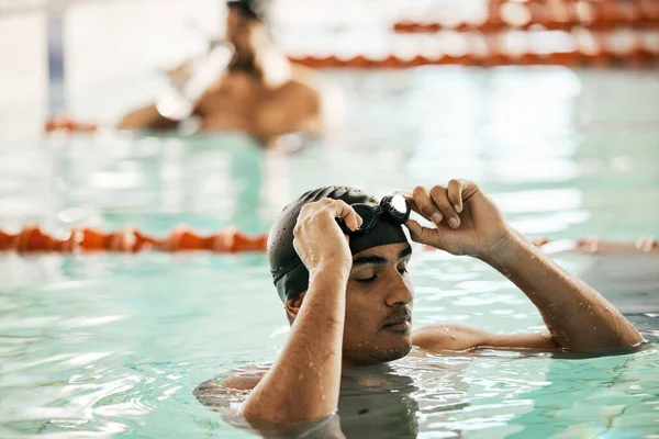 Swimming pool, man and sport athlete for workout and training race in professional gym. Male person, fitness and exercise for water competition in a health and wellness club for pool and athlete.