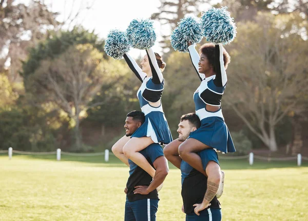 Cheerleader, sports and men carry women on field for performance, dance and motivation for game. Teamwork, dancer and people balance and cheer for support in match, competition and event outdoors.