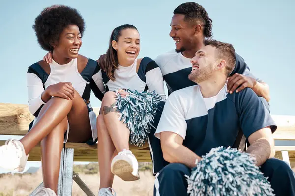 Cheerleader, sports and people laugh on bench for performance, dance and motivation for game. Teamwork, dancer and people laugh in costume for support in match, competition and field event outdoors.
