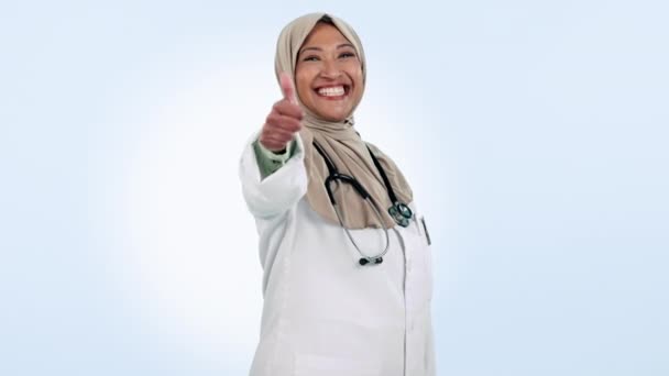 イスラムの女性と親指の医師 青いスタジオの背景に関するサポートと合意 肖像画 幸せなイスラム教徒の人と手のジェスチャー 絵文字とアイコンのようなヘルスケアのプロフェッショナル — ストック動画