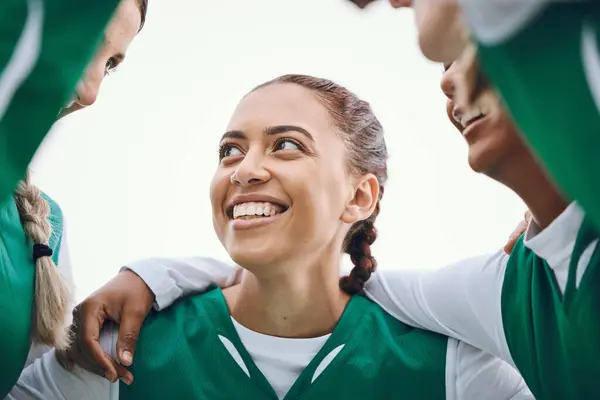 Happy, woman and team huddle in sport, game or conversation on field for advice match in soccer competition. Football player, group or support in exercise, workout or training collaboration together.