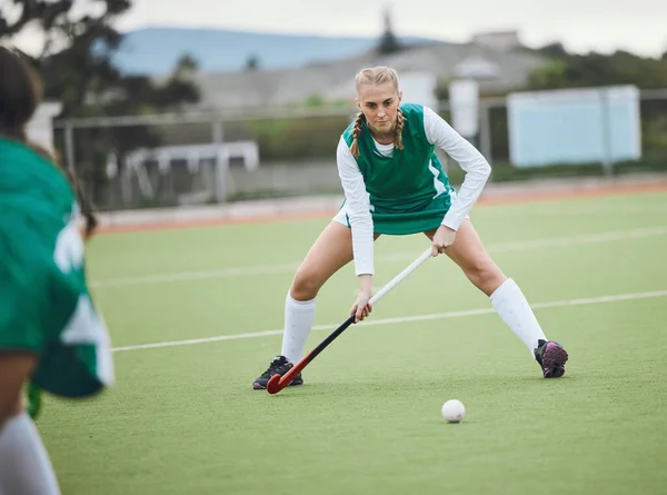 Field, hockey and woman in sports, game or action in competition with ball, stick and team on artificial grass. Sport, teamwork and women play in training, exercise or workout for goals in match.