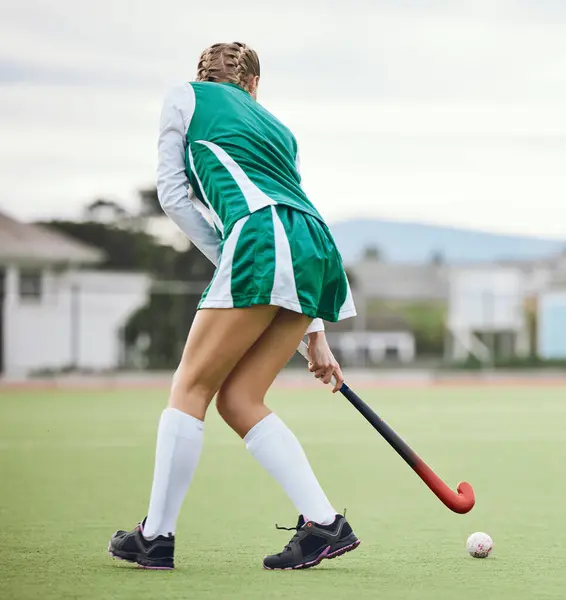 Field, hockey and woman running in game, tournament or competition with ball, stick and action on artificial grass. Sports, athlete and play in training, exercise or workout on green, pitch or ground.