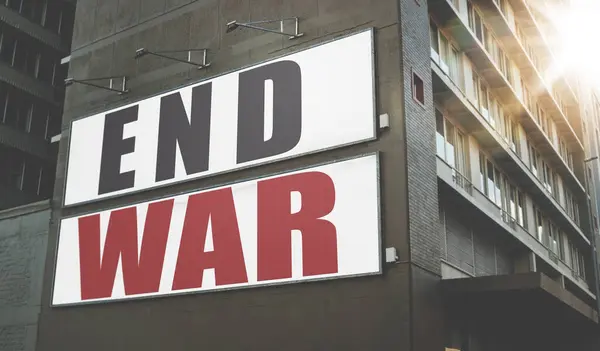 Billboard, poster and information on building, wall and war, propaganda or advertising activism campaign in city. End, conflict and sign or banner to protest politics, violence or global crisis.