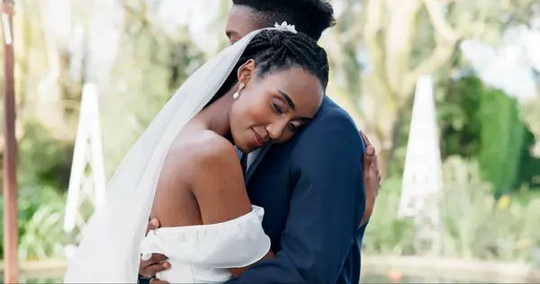 Happy, couple and dance at outdoor wedding with bride and groom with slow, movement and peace together. Calm, happiness and black woman dancing with head on man shoulder and love, support or marriage.