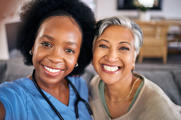 Selfie, smile and assisted living caregiver with an old woman in the living room of a home together. Portrait, support or community with a happy nurse or volunteer and senior patient in a house.