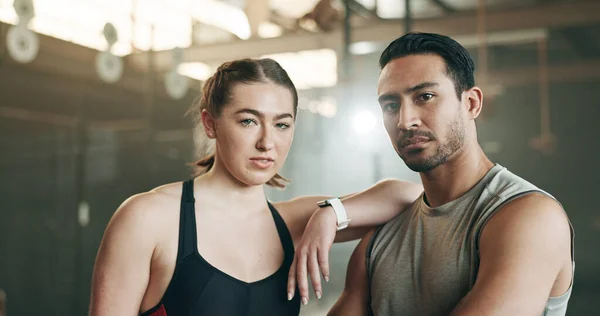 Fitness, friends and face in gym with confidence, workout and exercise class. Diversity, young people and wellness portrait of serious athlete with coach ready for training and sport at a health club.
