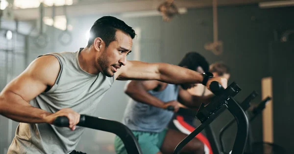 People, diversity and cycling at gym in workout, exercise or intense cardio fitness together and motivation. Diverse group burning sweat on bicycle machine for healthy body, wellness or lose weight.