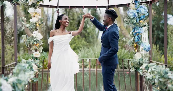 Wedding, first dance and black couple in garden with love, celebration and excited for future together. Gazebo, man and woman at marriage reception with flowers, music and happiness at outdoor party