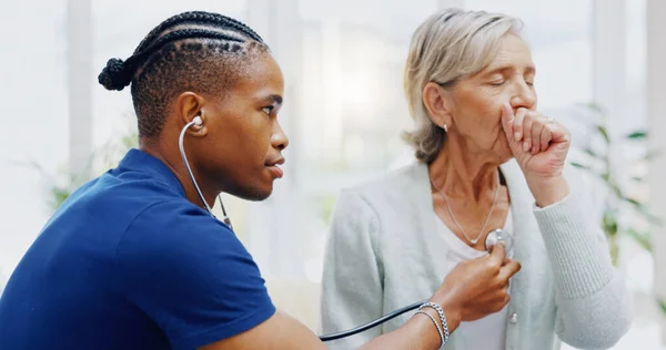 Nurse, elderly woman and stethoscope for cough test for healthcare, wellness or listening for breathing problem. Nursing home, listen or breathe with doctor black man, senior female patient for lungs.