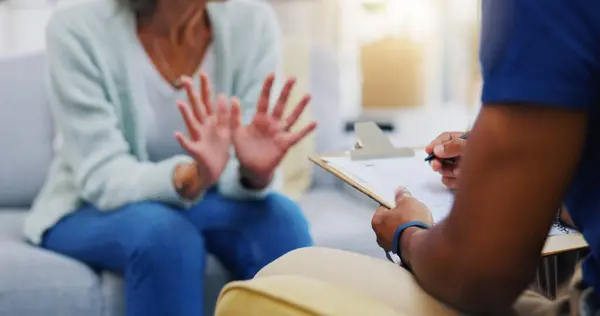 Person, hands or consulting a therapist writing on clipboard notes for healthcare service of cancer therapy. Closeup, nurse or sick patient talking in consultation with paperwork report documents.
