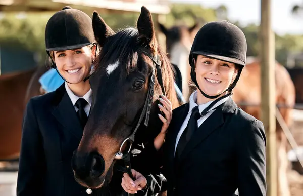Equestrian women, friends and horse in portrait, smile and outdoor for sports, training and workout for show. Girl team, animal and happy at farm, stable and together for race, competition or games.