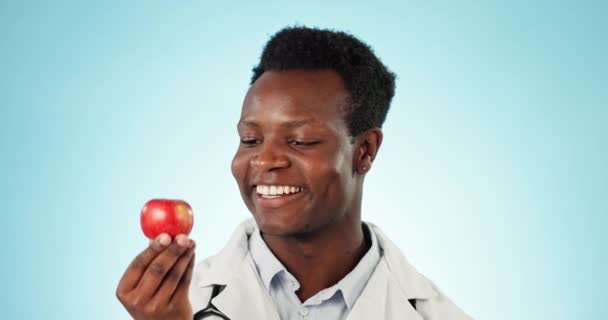 用于健康饮食 健康和自然营养的苹果工作室 指向和医生的脸 肖像和非洲男子 以水果为食物 维生素和蓝色背景的药物 — 图库视频影像