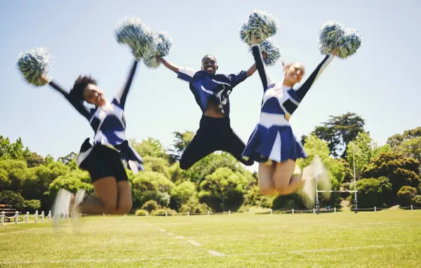 Cheerleader team, smile and people jump for performance on field outdoor in training, celebration or exercise. Happy, cheerleading group and energy for support at event, sport competition and blur.