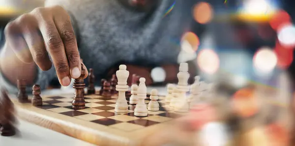 Hand, chess and board game with moving, strategy and choice in competition, problem solving and bokeh. Person, toys and contest with queen, king or check with knowledge, solution or closeup with idea.