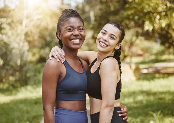 Fitness, smile and portrait of friends in a forest after workout, exercise and outdoor training together with support and care. Happy, nature and women hug in morning ready for wellness teamwork.