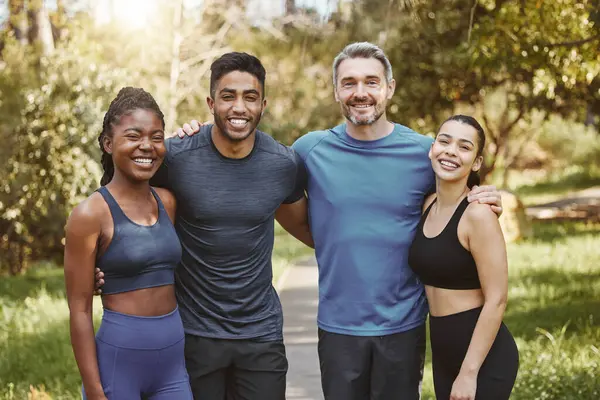 Fitness, group and people hug for portrait, athlete team and support for sport and health. Exercise friends, diversity and healthy with challenge, training together with workout and trust in forest.