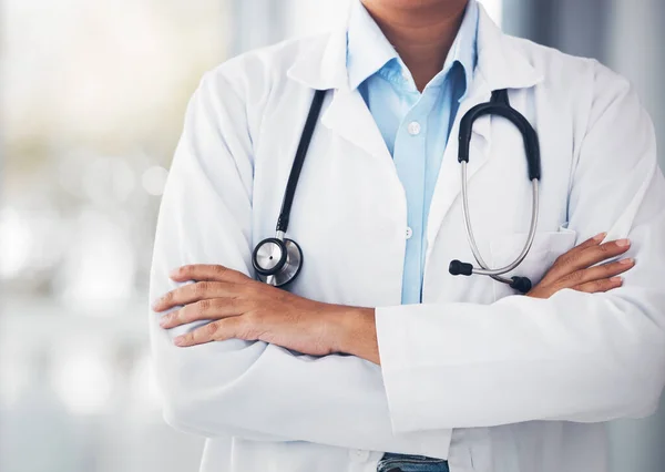 stock image Person, hands and professional doctor with arms crossed or stethoscope for cardiology or healthcare at hospital. Closeup of confident medical nurse or surgeon expert for health advice or emergency.