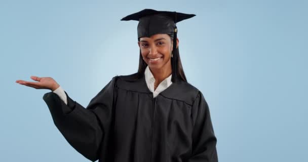 Happy Woman Graduation Pointing Palm Advertising Marketing Blue Studio Background — Stock Video