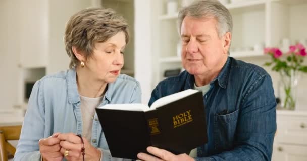 读圣经 圣经和基督教的老两口 对圣经有精神信仰 一起在家里的客厅里敬拜 宗教和老年人学习上帝或信仰经文 — 图库视频影像