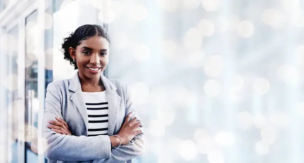 stock image Black woman, arms crossed and portrait with a smile from business consultant work with mockup space. Confidence, female entrepreneur and professional from New York happy from startup by window bokeh.