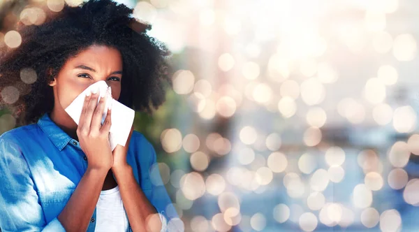 Black woman, blowing nose and allergies, sick with health fail on banner and bokeh, portrait and sinus infection. Healthcare, wellness and illness with mockup space, toilet paper for cold or flu.