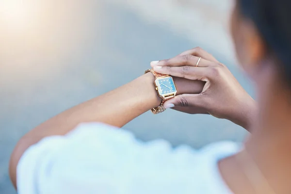 Closeup, woman and arm with watch for time management with elegance for business meeting in city. African person, entrepreneur and waiting by delay, check or late for transport to commute to client.