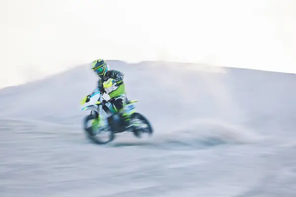 Blur, fast motorbike and man in desert for sports, action adventure or extreme travel on dirt on mockup space. Off road, sand and driver on motorcycle for speed in nature, competition race or freedom.