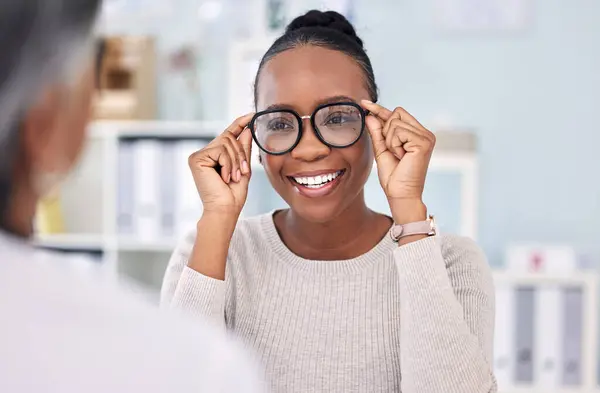 Eye care, glasses choice and black woman with optometrist at clinic, vision and healthcare with wellness. Prescription lens, frame with help or advice, designer eyewear or spectacles with smile.