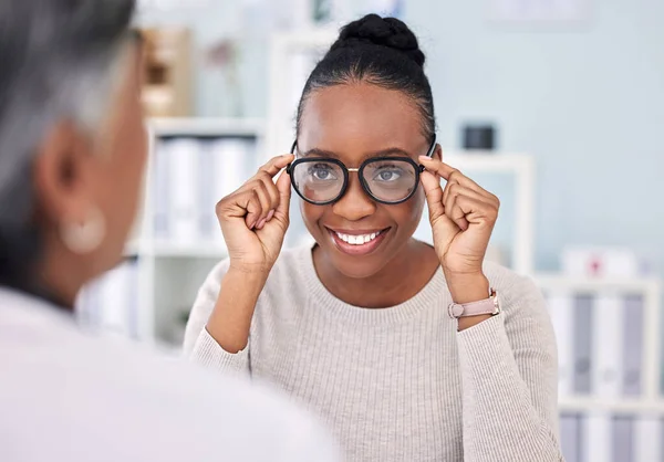 Eye care, glasses and black woman with optometrist, vision and healthcare with wellness and choice at clinic. Prescription lens, frame with help or advice, designer eyewear or spectacles with smile.