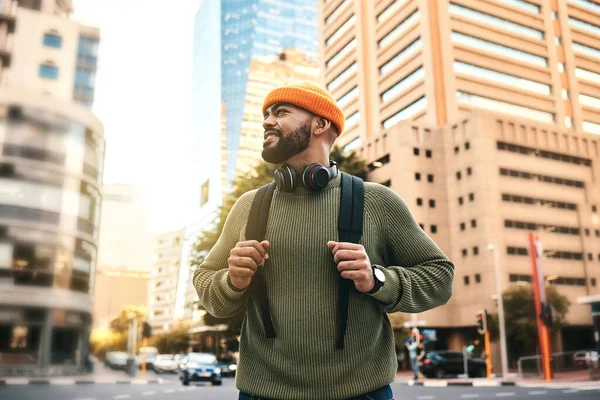 Man in city, backpack and smile on morning commute to university campus for education with buildings. Opportunity, study and happy gen z college student, walking on urban street and travel to school