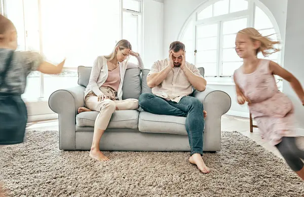 Frustrated Couple Children Running Living Room Chaos Headache Stress Sofa — Stock Photo, Image