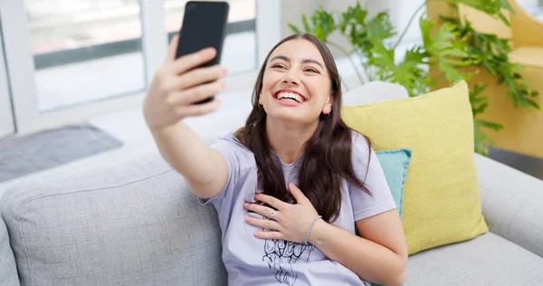 Woman, selfie and sofa with smile, home and happy for post on web blog, internet and relax in living room. Influencer girl, excited and photography for memory, profile picture and social network app.