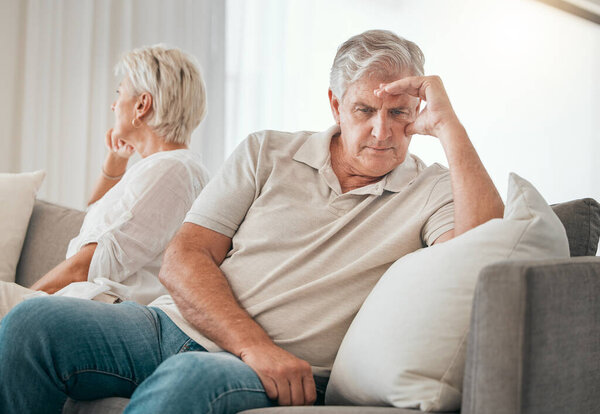 Ignore, senior couple and divorce on sofa in home living room for conflict, fight or stress for marriage crisis. Elderly man, woman and depression, angry at mistake or frustrated at relationship fail.