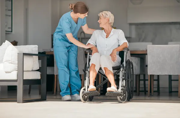 Old woman in wheelchair, trust or caregiver talking for healthcare support at nursing home. People, help or nurse speaking to senior patient or elderly person with a disability for empathy or hope.