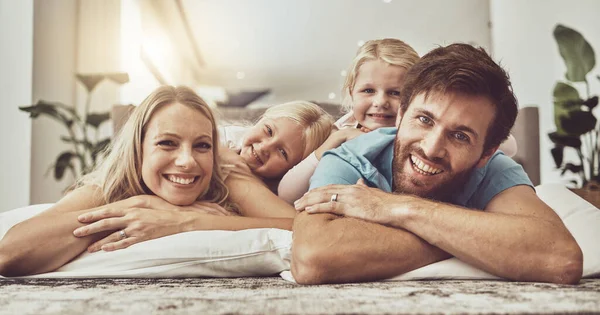Relax, happy family and parents with children on living room floor laughing together in the morning with happiness. Love, care and mother bonding with father and kids with memory, trust and smile.
