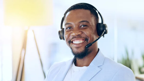 Portrait, call center and happy black man in telemarketing, support and help desk in office in Nigeria. Customer service, sales agent and face smile of African business professional in headphones.