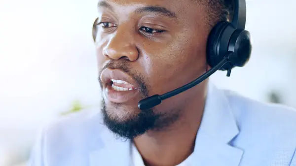 Crm, call center and black man talking for telemarketing, tech support or help desk in office. Customer service, sales agent and serious African consultant in communication, online advice or business.